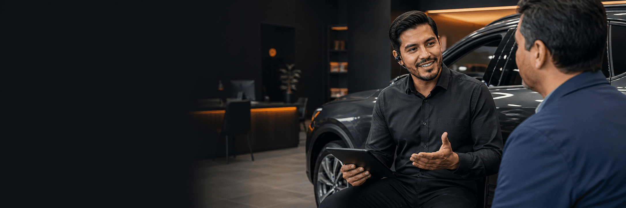 Next Car advisor guiding a customer beside a vehicle